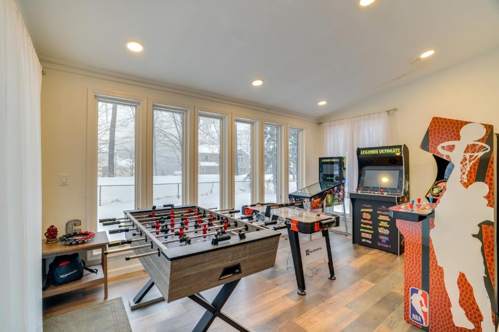 a game room with a foos ball and a video game at Cozy Tobyhanna Cottage with Private Hot Tub! in Tobyhanna