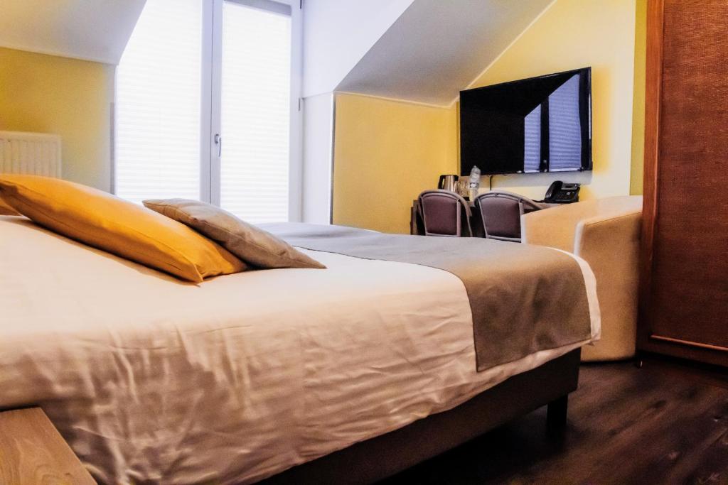 Postel nebo postele na pokoji v ubytování Hotel des Postes