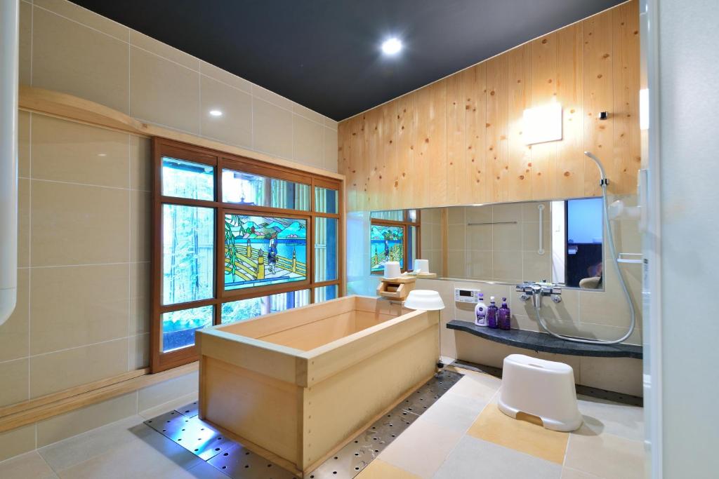 a large bathroom with a tub and a sink at Takeya Kitano Honkan in Kyoto