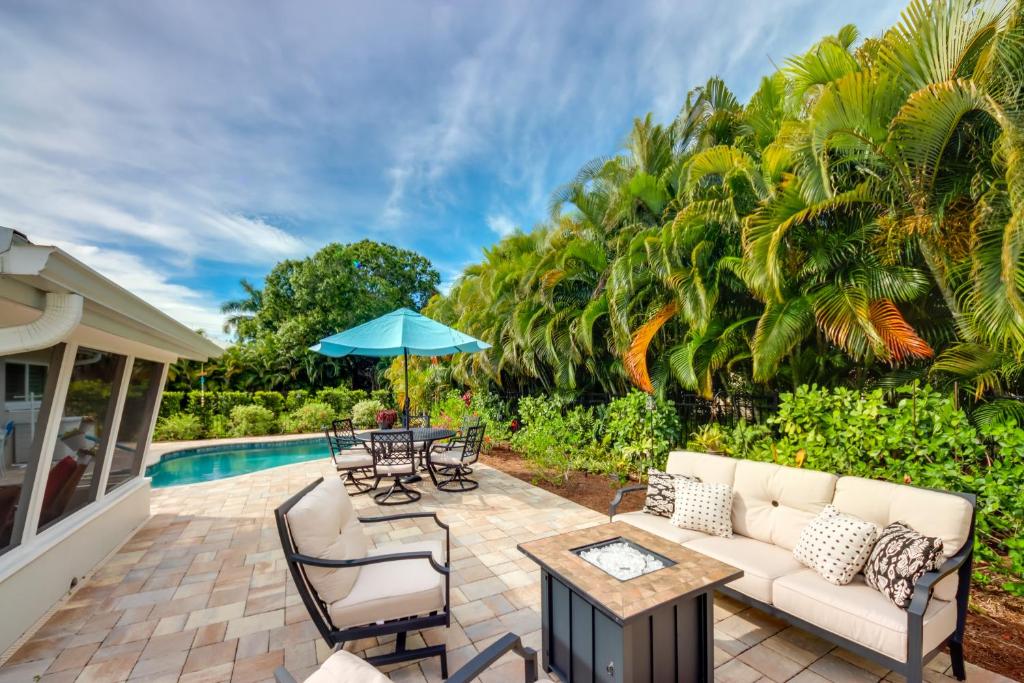 a patio with a couch and chairs and a table at Lush Punta Gorda Escape Private Pool and Lanai in Punta Gorda
