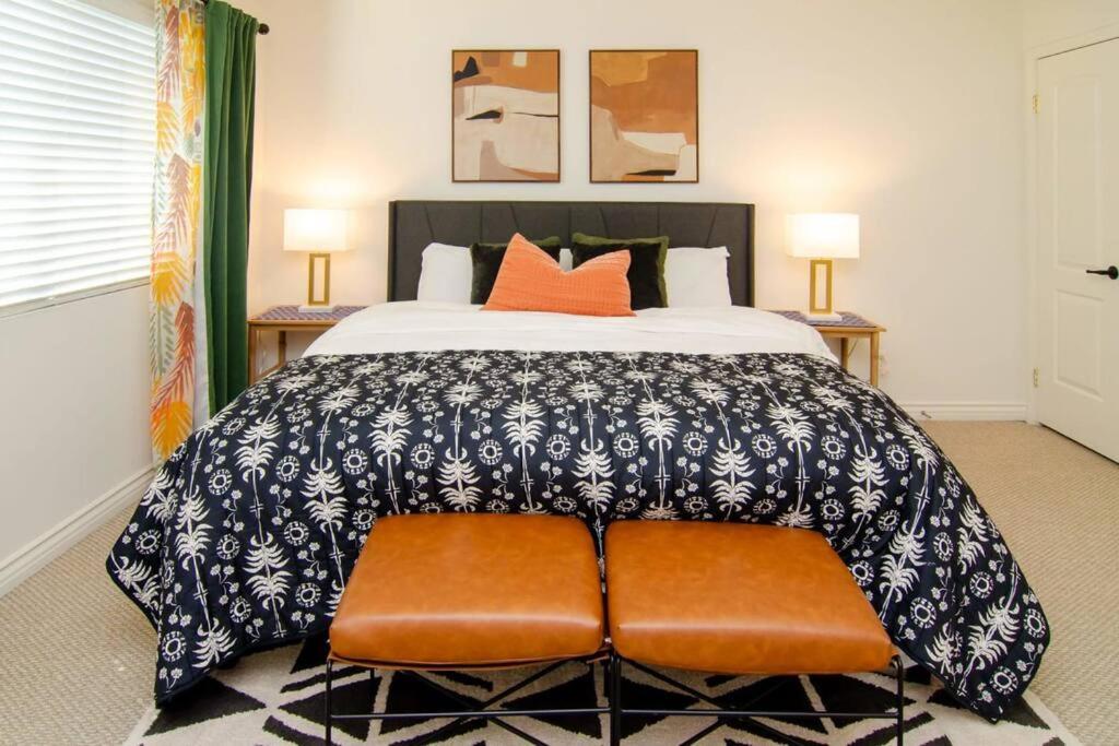 um quarto com uma cama grande e almofadas laranja em Up to 20% off weekly stay 3BR 2.5 miles to airport em Ontario