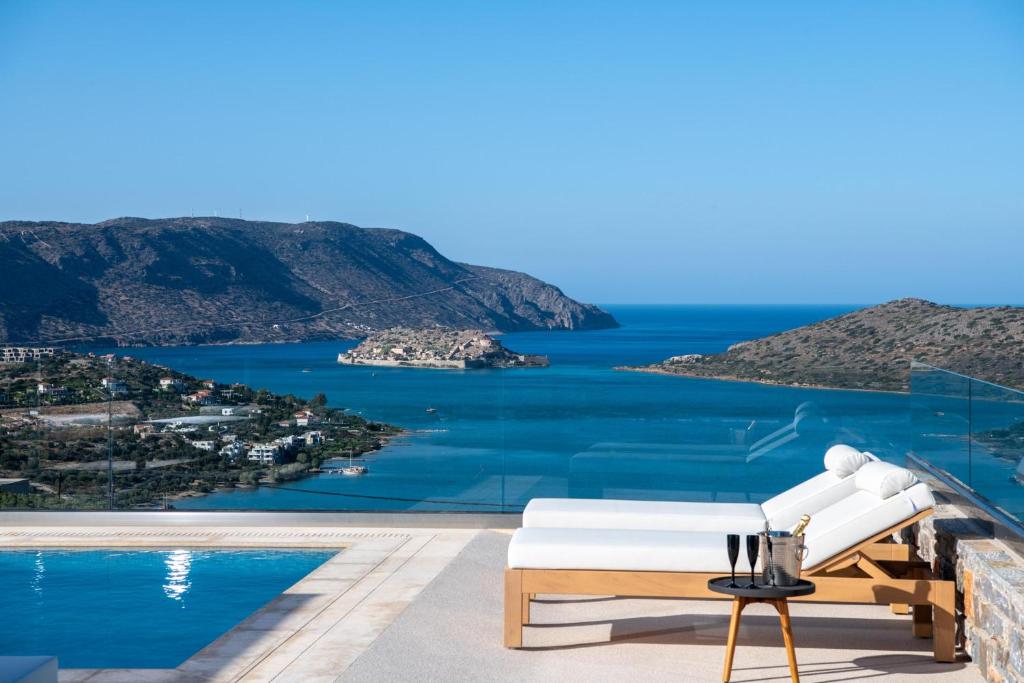 a villa with a view of the ocean wallpaper at Elounda Bright Villa in Elounda