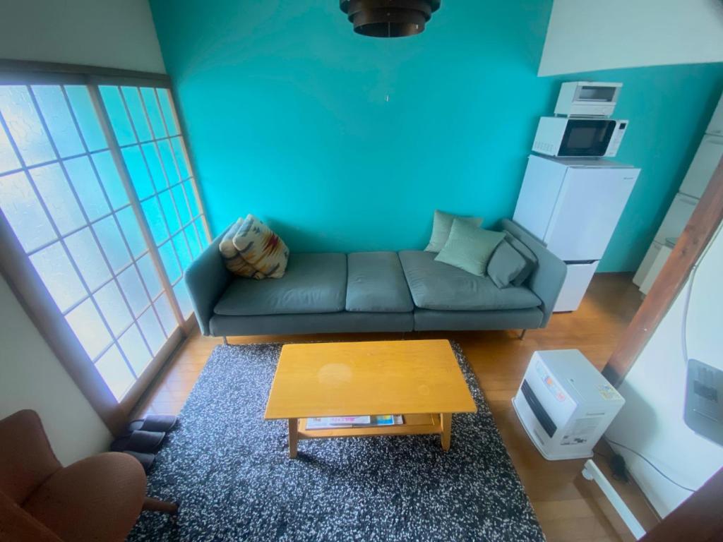 a living room with a couch and a table at KAMEYA HOUSE ENOSHIMA - Vacation STAY 01325v in Fujisawa