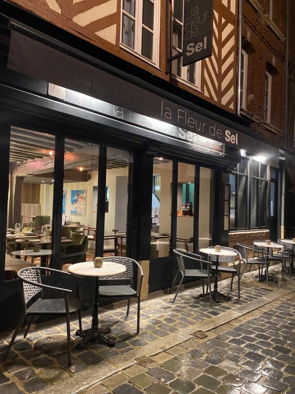 a group of tables and chairs outside of a restaurant at La Fleur de Sel in Honfleur