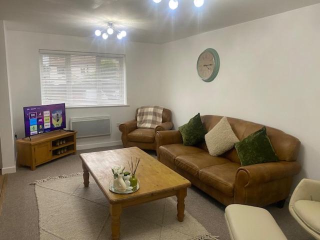 a living room with a couch and a coffee table at Shepshed 2 Bedroom Apartment in Shepshed