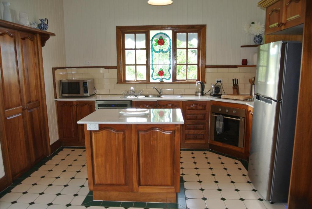 a kitchen with a sink and a refrigerator at Ocean Serenity in Mission Beach