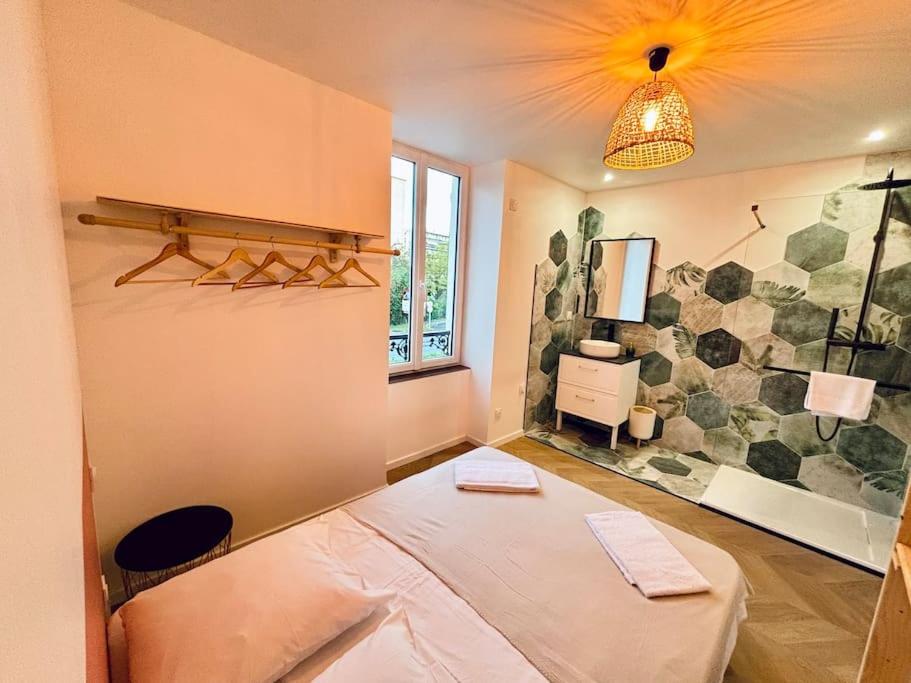 een kamer met een bed in de hoek van een kamer bij Bel appartement proche gare #3 in Bourgoin