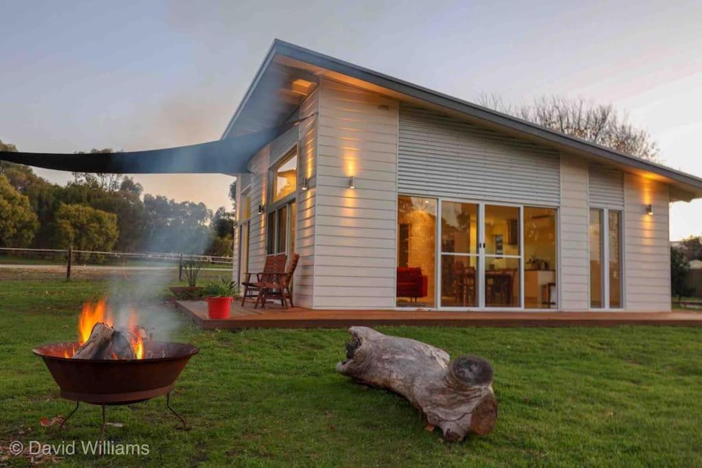 a house with a fire pit in the yard at Glenberrie Place ECO Retreat in Kangarilla