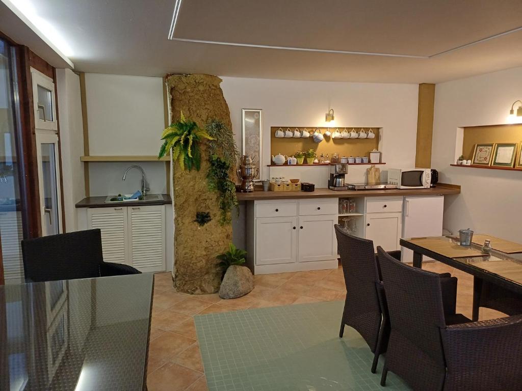 a kitchen with a table and chairs and a stone column at Pension Hayna Zi. 1 und Zi. 2 in Schkeuditz