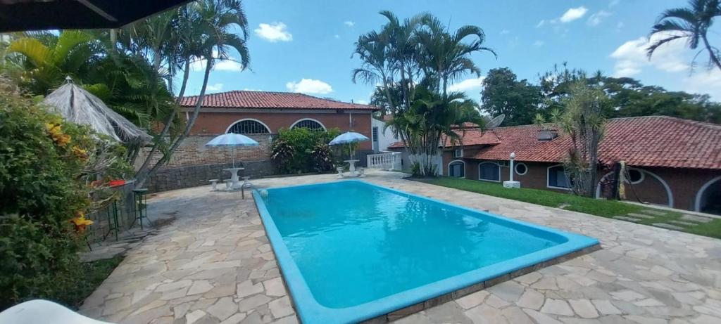 a swimming pool in the backyard of a house at Palace Hotel Jacarezinho in Jacarèzinho