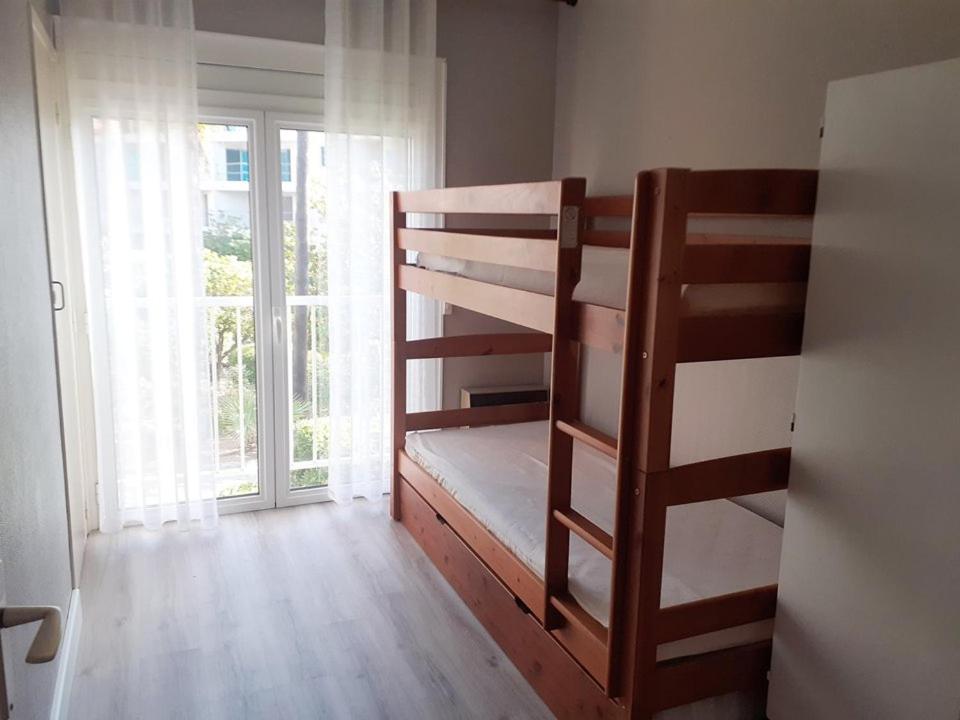 Łóżko lub łóżka piętrowe w pokoju w obiekcie 3 pièces 6 pers à 2 pas de la plage et du centre ville