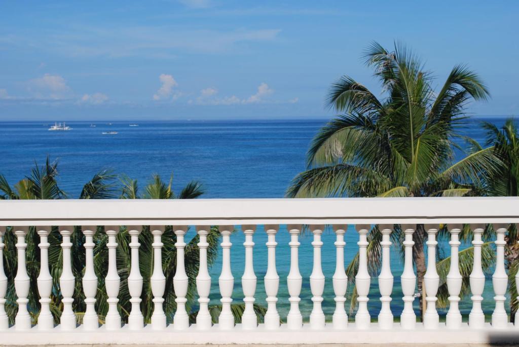 a white balcony with the ocean in the background at Boracay Sands Hotel in Boracay
