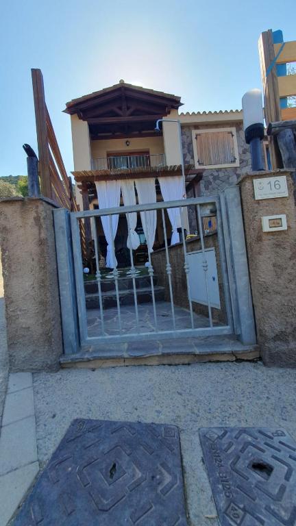 a house with a gate in front of it at VillaVittoria in Chia