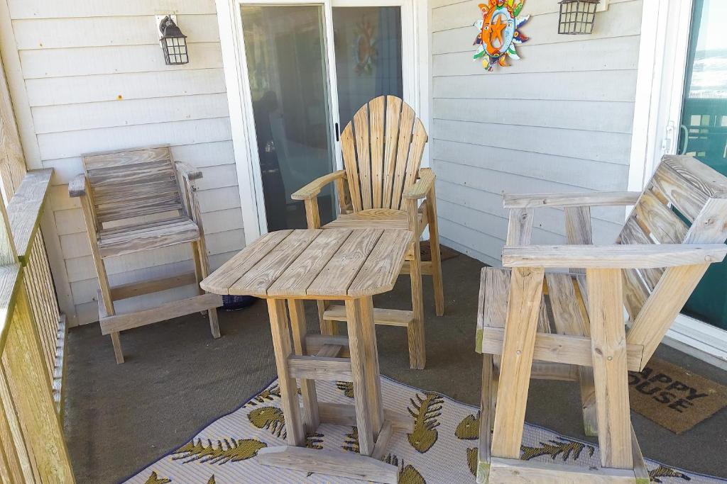 two chairs and a bench on a porch at Seven B Heaven in Rodanthe