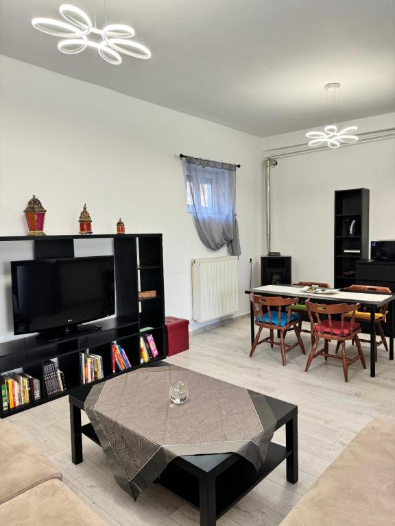 a living room with a table and a dining room at Thomais Guesthouse in Kavala