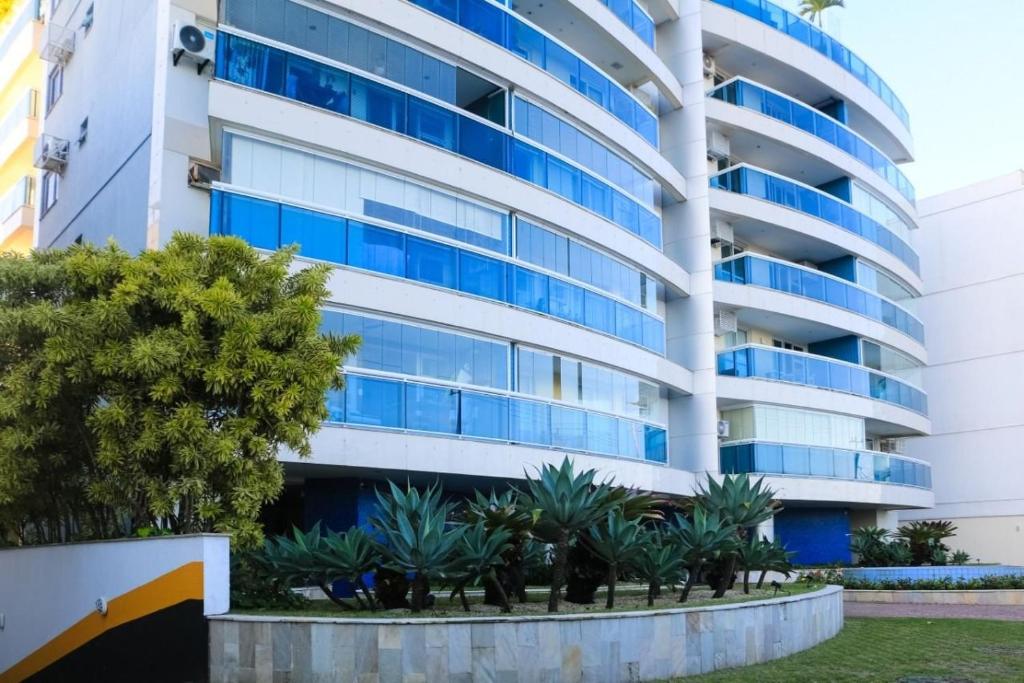 an apartment building with blue windows at LINKHOUSE LUXURY BEACHFRONT FLATS in Rio de Janeiro