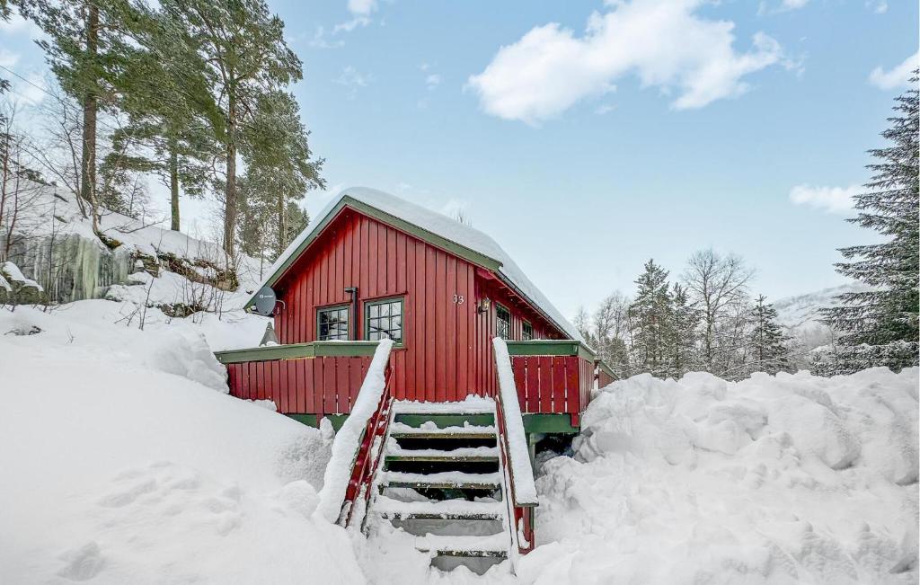 a red cabin with snow around it at Awesome Home In seral With Wifi in Åseral