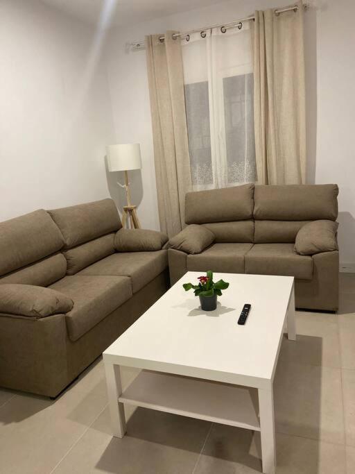 a living room with a couch and a coffee table at Apartamento Baeza 4A in Baeza