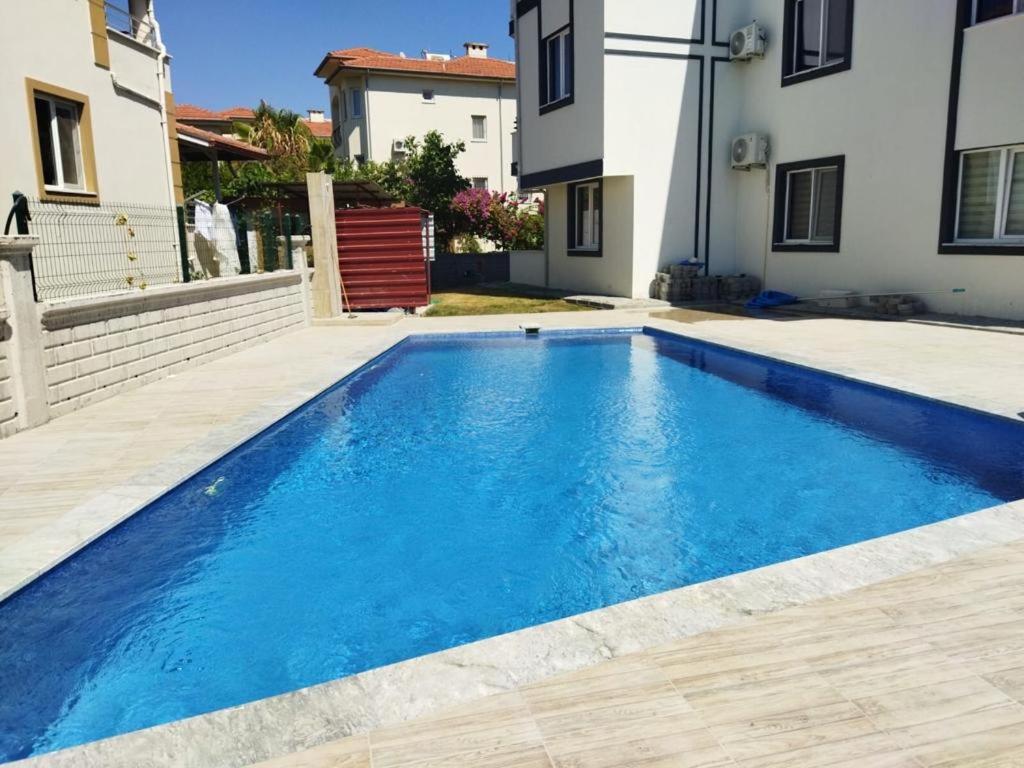 a swimming pool in a yard next to a house at Dalaman Apart Vacance , Ozgün Deniz Sitesi No 5 in Dalaman
