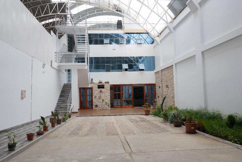 a large white building with a glass ceiling at Estancia Entre Las Nubes in Chachapoyas
