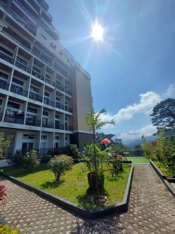 a building with a garden in front of it at Evergreen Suites Cozy Baguio Loft Retreat in Baguio