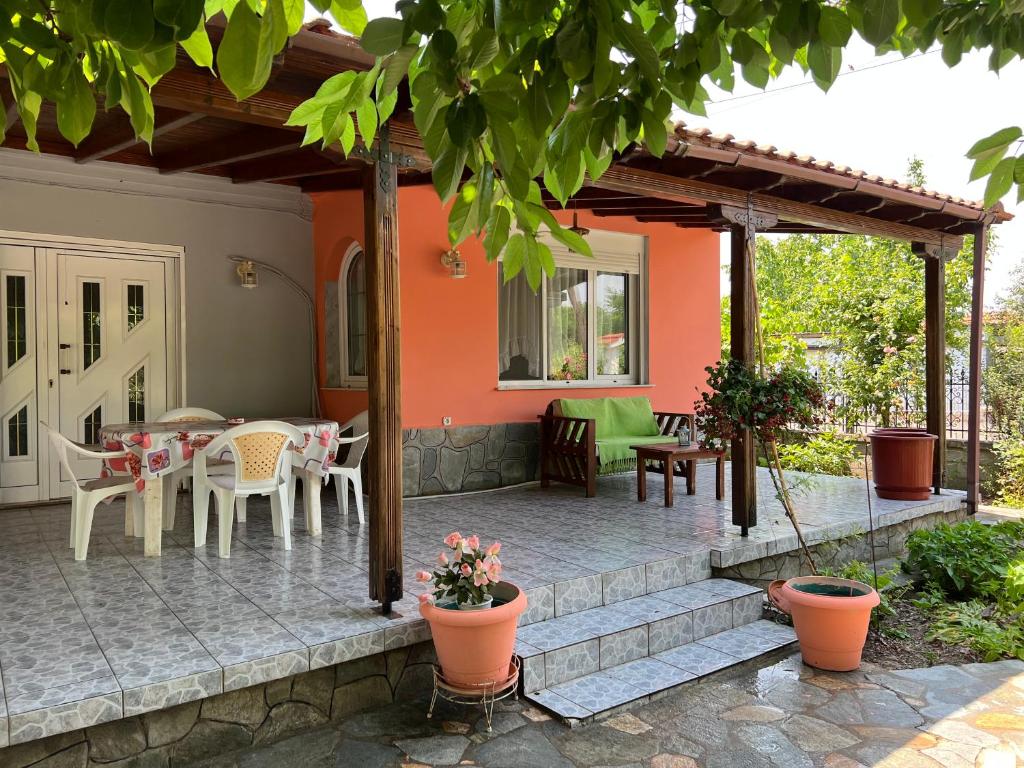 a patio with tables and chairs on a house at Monastiraki Villa in Keramoti