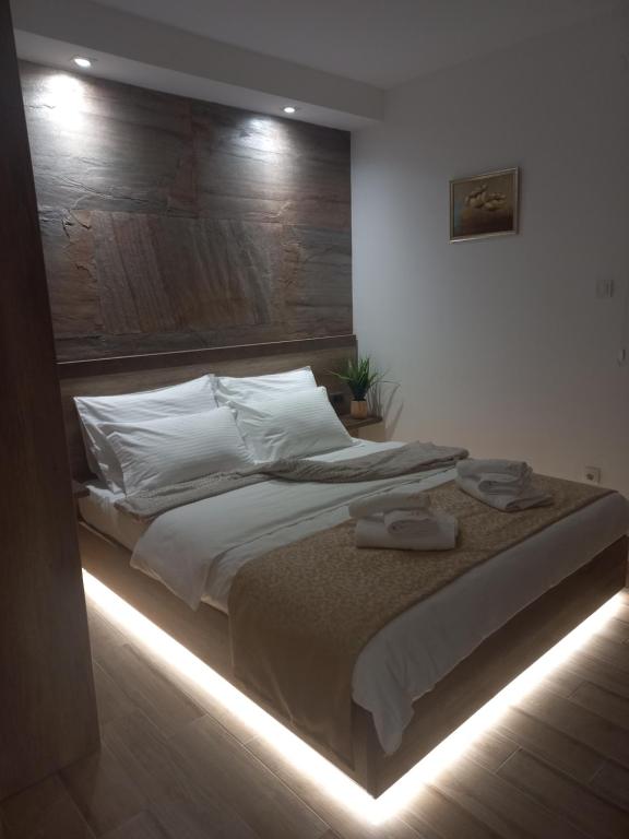a bedroom with a bed with lights on it at LUX Apartman AS - Montevia in Zlatibor