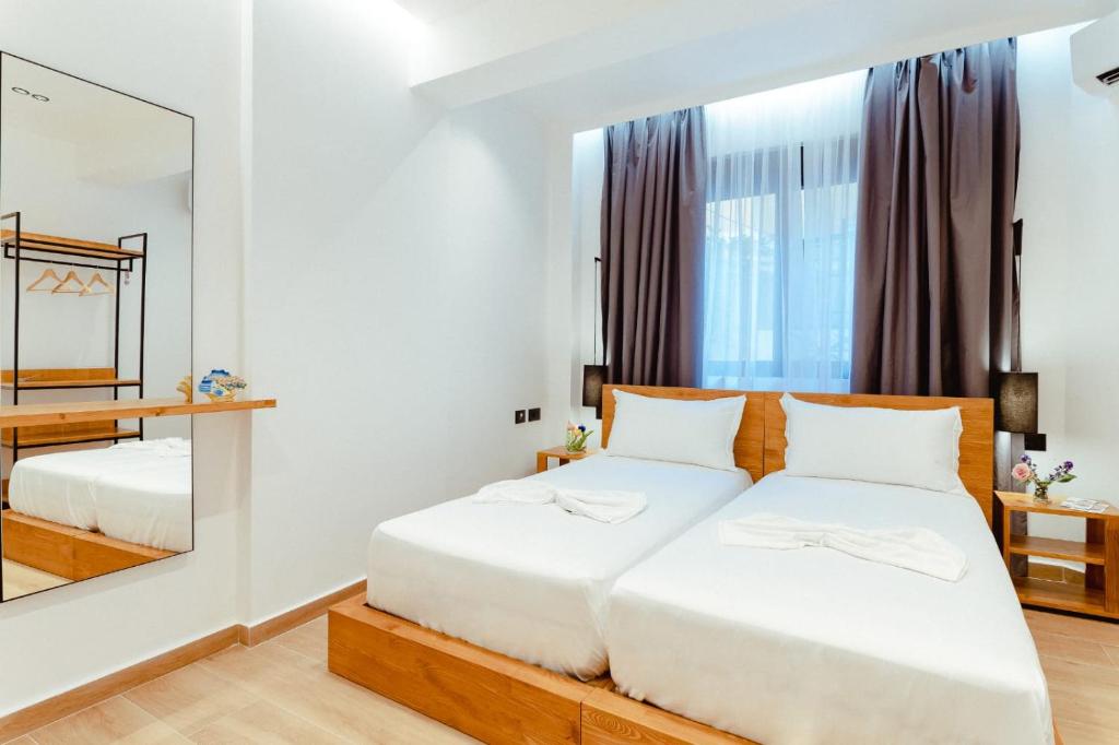 Postel nebo postele na pokoji v ubytování Gloal Suites & Residence