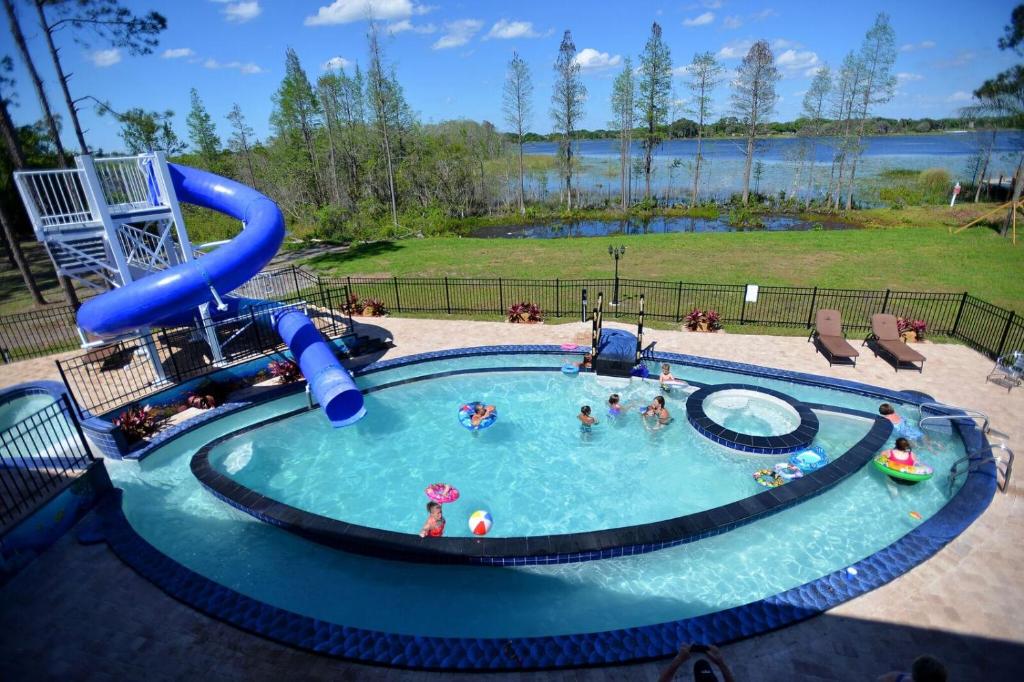 a group of people in a swimming pool at 10 Acre Lakefront Game House - Sleep Upto 45 in Clermont