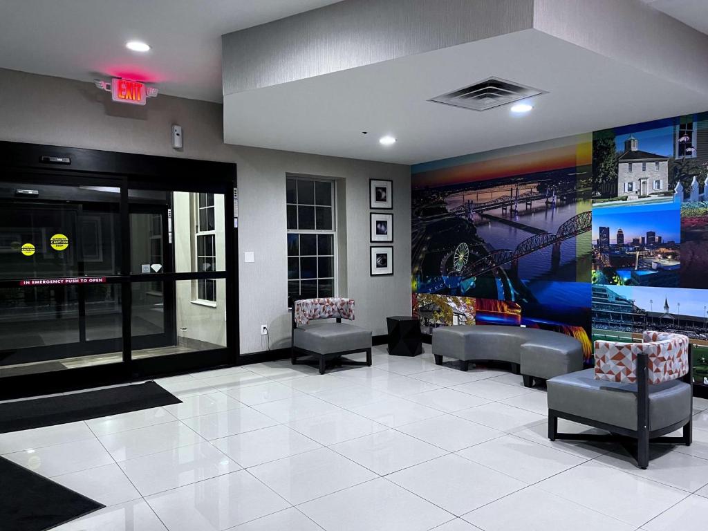 a waiting room with couches and a large mural at SureStay Plus by Best Western Corydon in Corydon