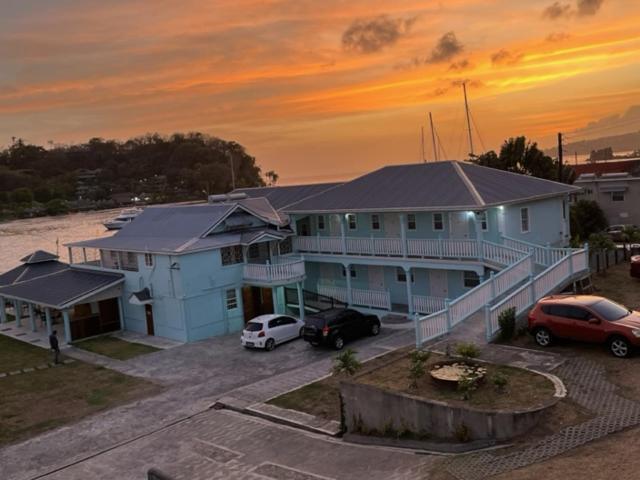 a large house with cars parked in a parking lot at Basil At Villa in Arnos Vale