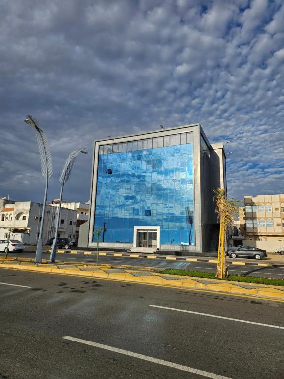 SEAGULL HOTEl في أملج: مبنى بحائط ازرق على جانب شارع