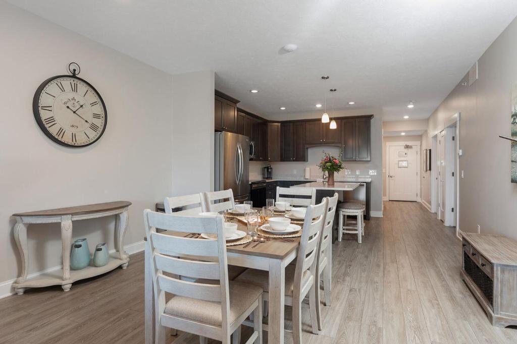 a dining room with a table and a clock on the wall at 539 Bay St in Traverse City