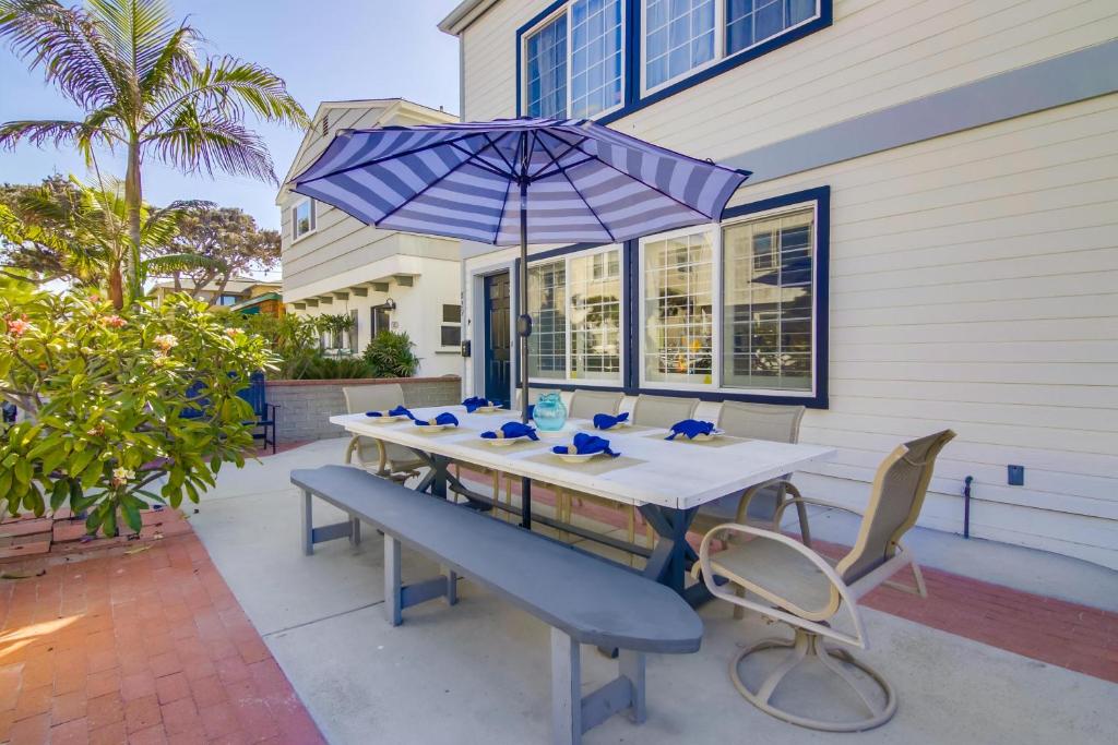 a table with an umbrella and chairs on a patio at Fantastic bayside vacation home - WiFi, central AC, patio, private washer & dryer in San Diego