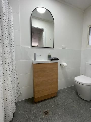 ein Badezimmer mit einem Waschbecken, einem WC und einem Spiegel in der Unterkunft Pichi Richi Park in Quorn