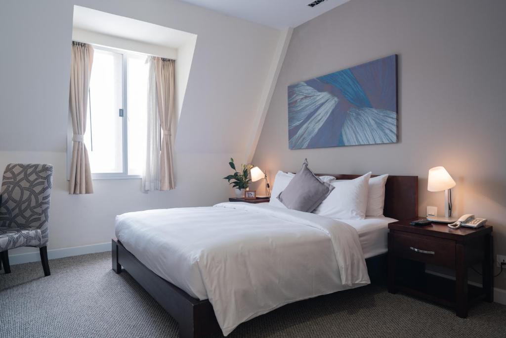 Postel nebo postele na pokoji v ubytování Central Mansions Serviced Apartments