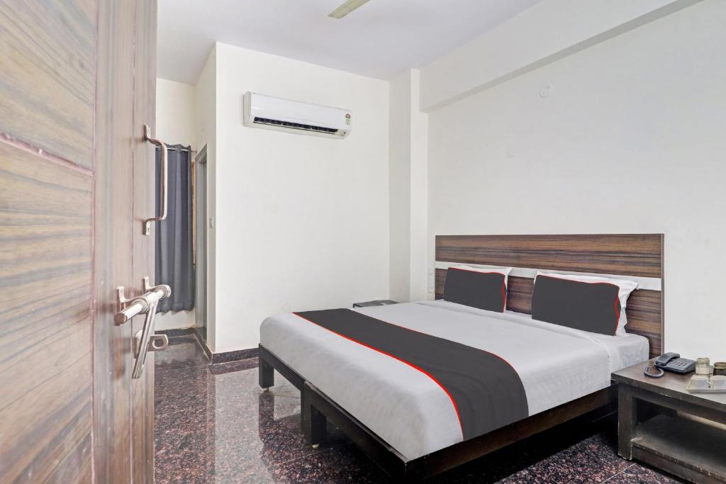 a hotel room with a bed and a table at 80977E SS Metro Ritz in Ameerpet