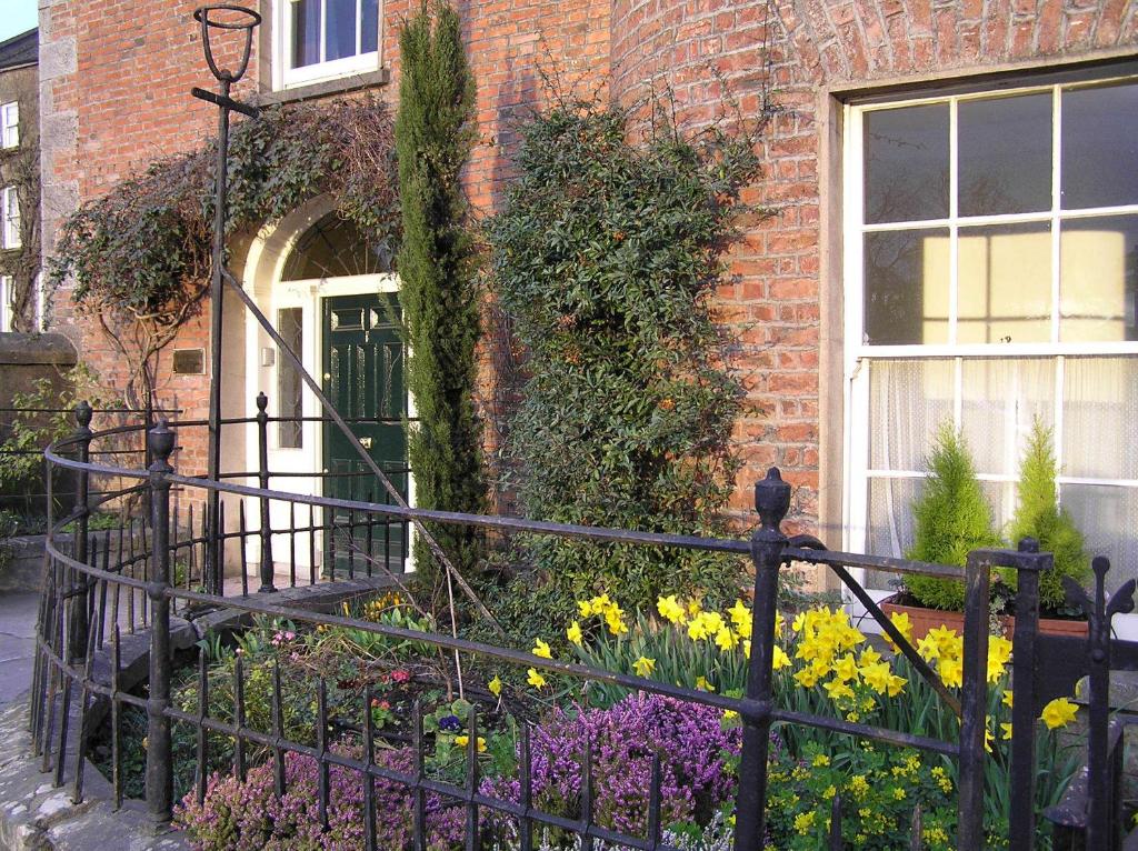 a house with a gate and flowers in front of it at Fishermen's Rest in Fermoy