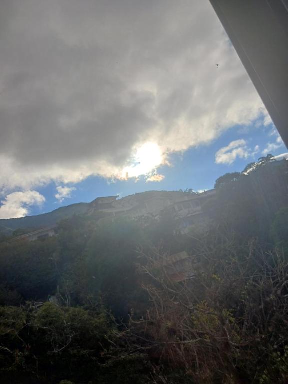 a view of a mountain with the sun in the sky at Habitación el mirador in San Rafael