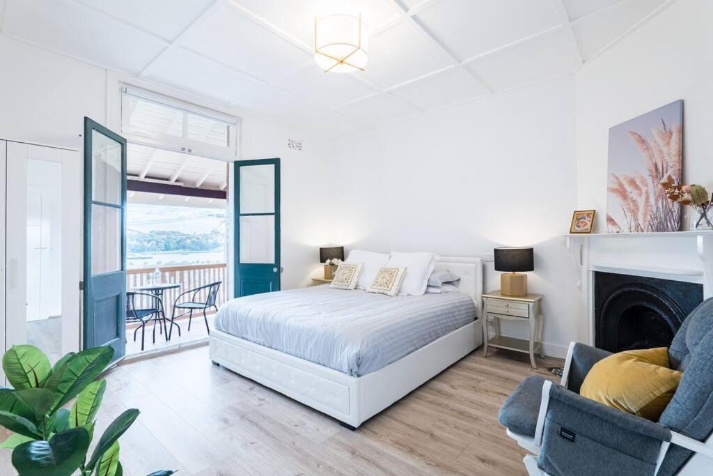 a white bedroom with a bed and a fireplace at Waterfront - KING Master 4 Bedroom 3 Storey#9-10 in Sydney