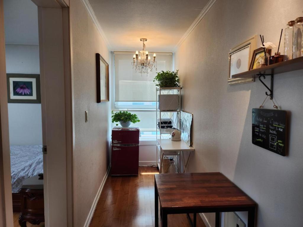 a dining room with a table and a window at Umi House in Busan