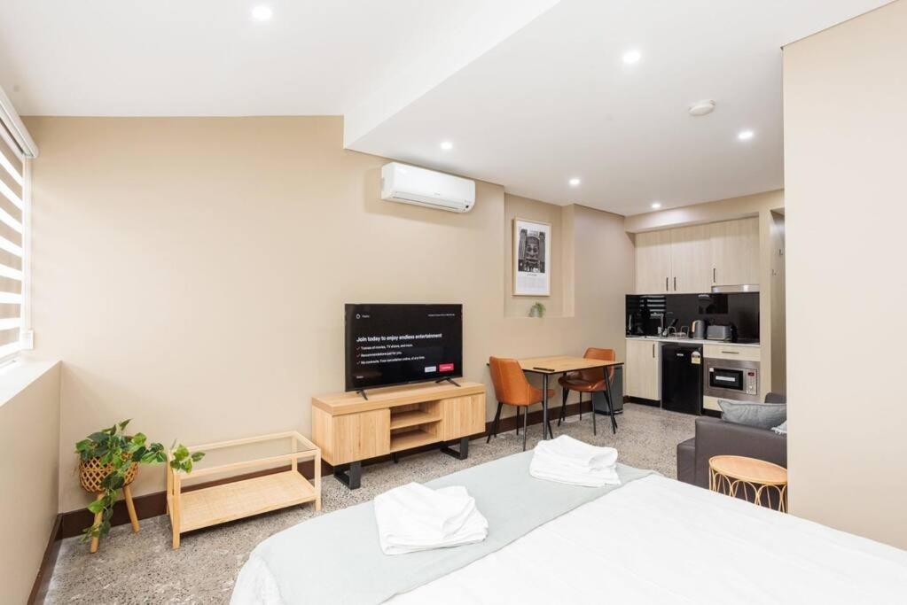 a bedroom with a bed and a living room at NEW! Ideal 1BR Unit in the Hot Spot of Surry Hills in Sydney