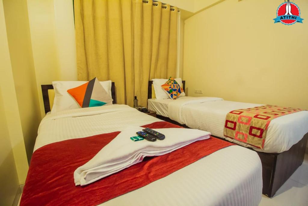 Postel nebo postele na pokoji v ubytování Atithi Service Apartment