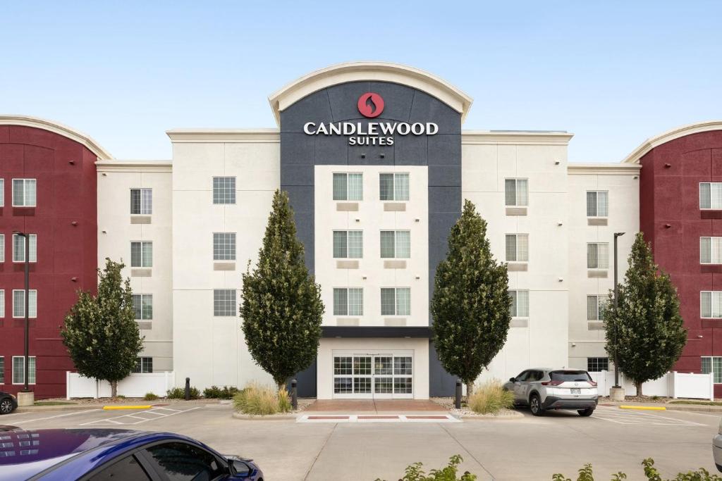 スーフォールズにあるCandlewood Suites Sioux Falls, an IHG Hotelの看板が貼られた白い大きな建物