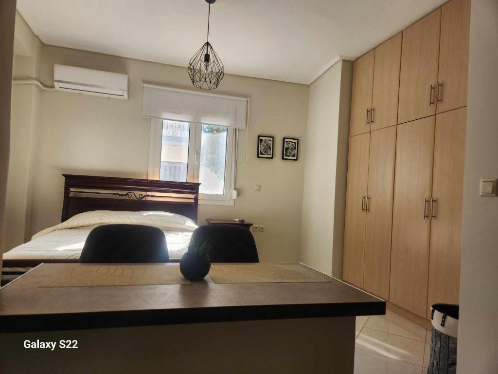 a bedroom with a bed and a desk with two chairs at George's Apartment in Volos