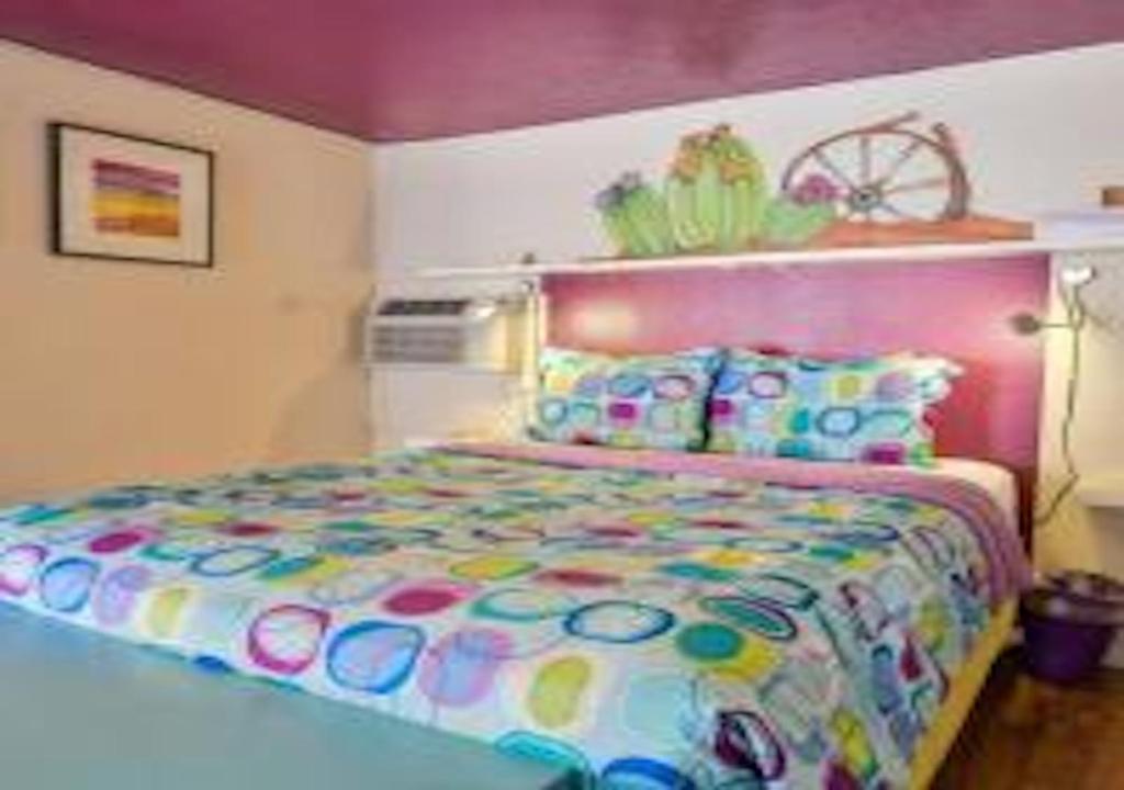 a bedroom with a large bed with a colorful bedspread at Starry Night Memories in Moab
