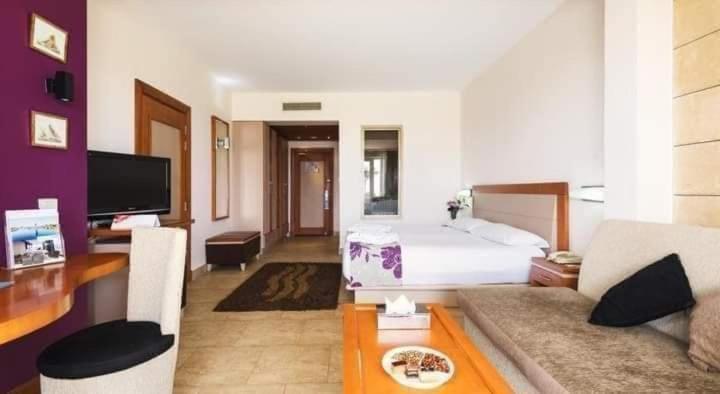 a hotel room with a bed and a couch at Hawaii hotels & blend club resort&sea jul& in Hurghada