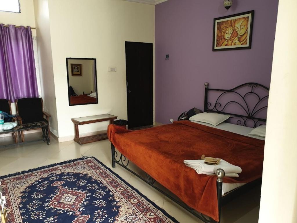 a bedroom with a large bed and a mirror at Hotel Third Eye in Pushkar