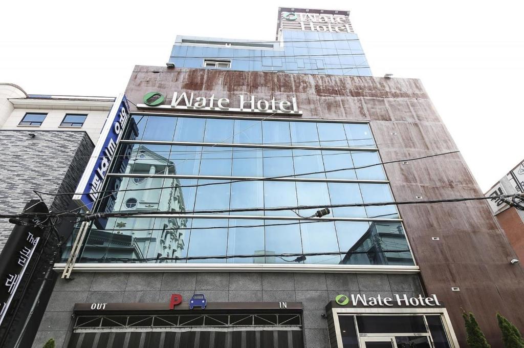 a building with a sign for a market hotel at Wate Hotel in Yeosu