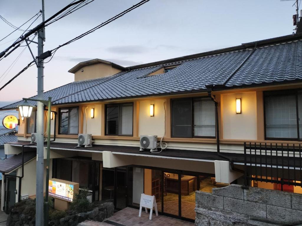 a house with lights on the side of it at Kannabi Ikomayama Hotel in Ikuma